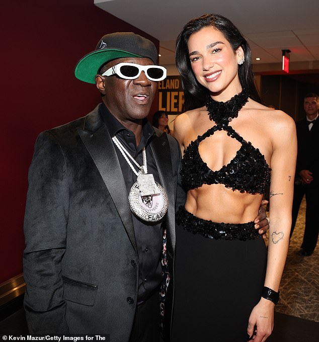 Inside the venue, she briefly posed with 65-year-old Flavor Flav before taking the stage to perform during the ceremony.