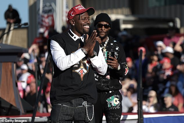 Former Pittsburgh Steelers players Antonio Brown, left, and Le'Veon Bell, right, are seen on stage as Brown spoke in support of Republican presidential candidate Donald Trump, during a campaign rally in Latrobe, Pennsylvania