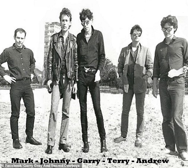 Andrew, pictured right, next to Garry Gray and Sacred Cowboys bandmates Mark Ferrie, Janis Friedenfelds, Garry Gray and Terry Doolan (L-R)