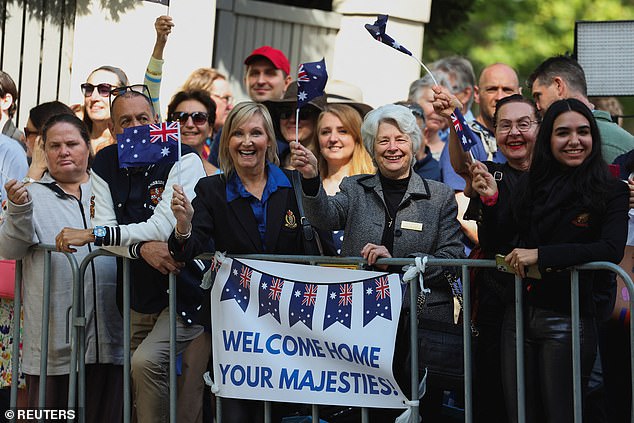 The crowd held signs reading 'Welcome home Your Majesties'