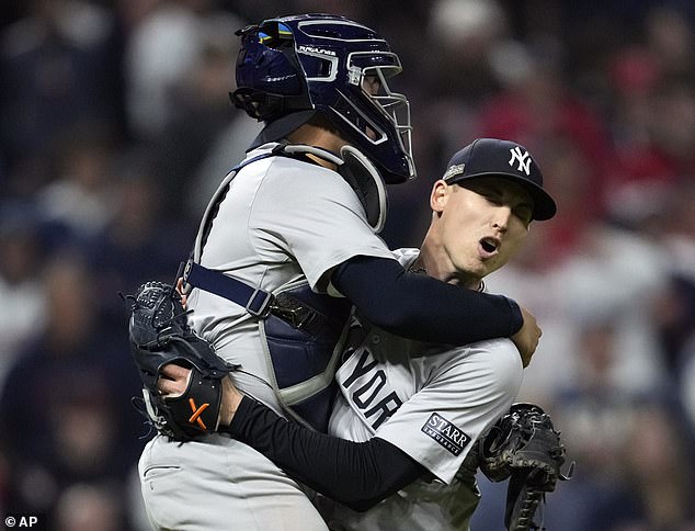 Catcher Austin Wells jumps into the arms of closer Luke Weaver after the final out of the ALCS