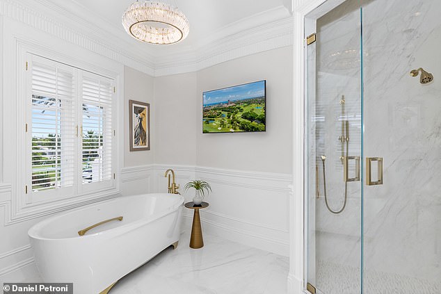 This is one of nine bathrooms that offer a mix of opulence and functionality, with a spacious walk-in shower