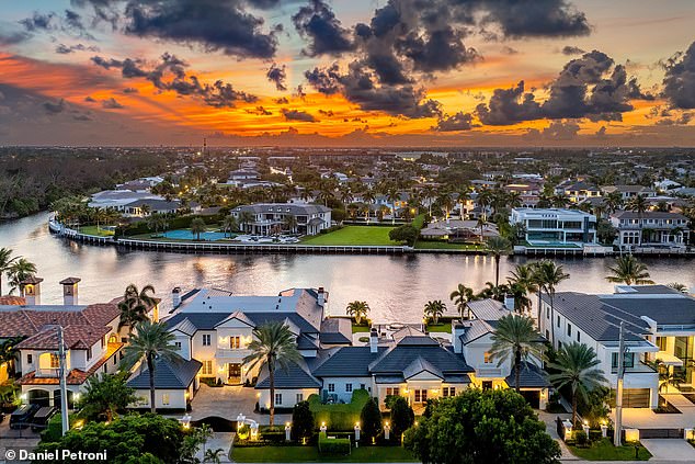 The gentle ripples of the water and lush greenery create a tranquil atmosphere as the home sits on the intracoastal waterway