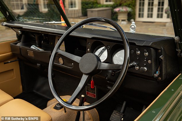 The driver's seat of the green open-top vehicle, which was specially equipped with traffic light buttons so that the late Queen could warn her driver when she wanted to stop and continue driving