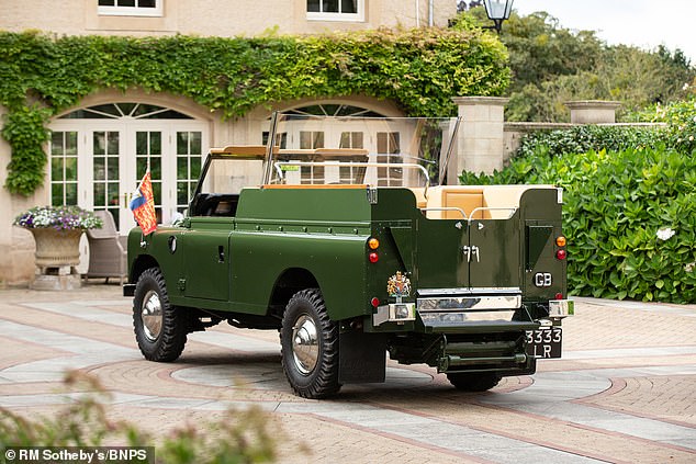 The back includes a rail and glass screen that allowed the monarch to stand while traveling in the classic car