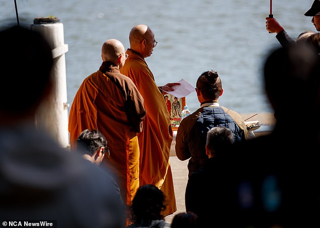 Buddhist monks led prayers and burned incense as the local Vietnamese community gathered around the father