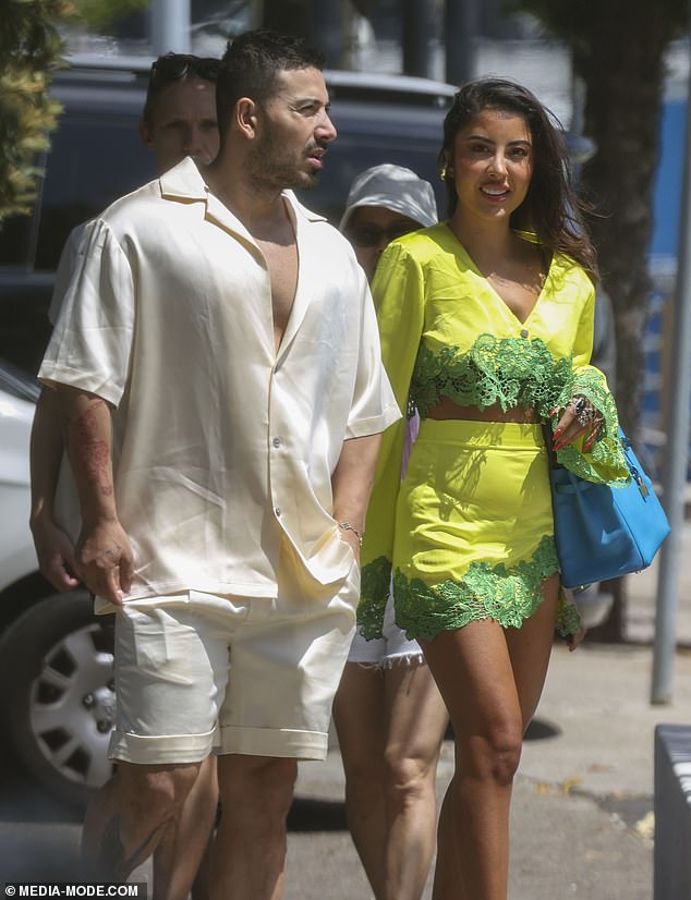 Jono, 33, showed off a hint of masculine cleavage in an oversized shirt in apricot with a wide, open neckline. He completed his look with shorts in the same delicate shade and a pair of white sneakers