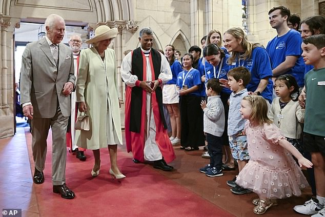 The King and Queen greet young well-wishers as they enter St. Thomas Church