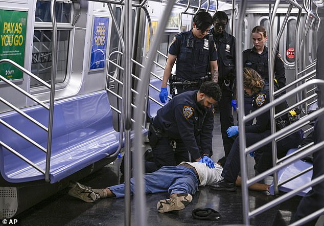 NYPD officers attempt to revive Jordan Neely as he lies on the floor of an F train on May 1