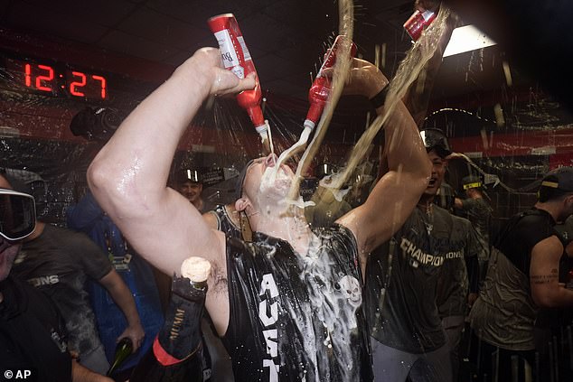 Tommy Kahnle is doused in booze as he drinks two beers during the festivities