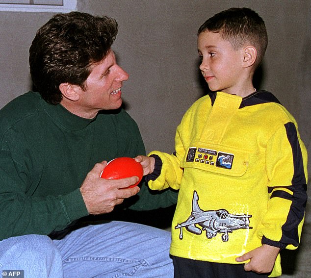 Pictured: Elian Gonzalez, six, receives a toy football as a Christmas gift from Donato Dalrymple of Fort Lauderdale, Florida, at the home of Elian's relatives in Miami, December 24, 1999. Dalrymple is the fisherman who helped rescue Gonzalez from the Straits of Florida months earlier