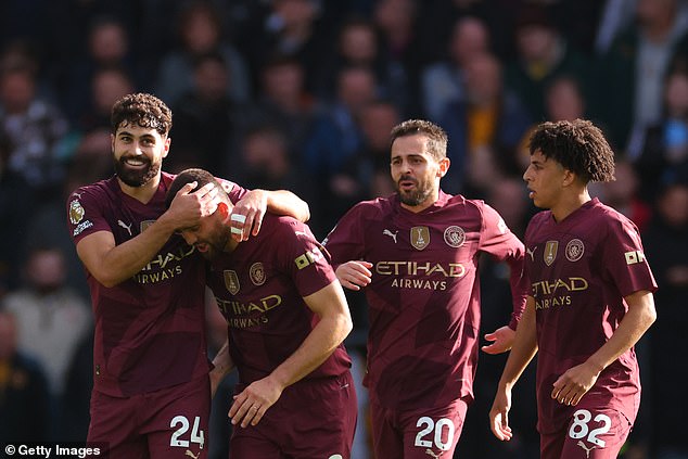 Gvardiol (left) and his City teammates celebrated his equalizer after Wolves opened the scoring