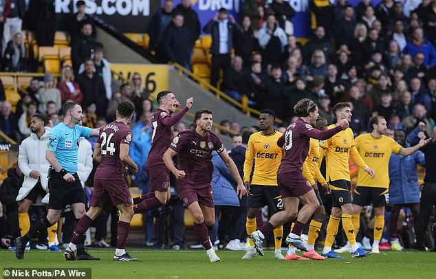 City players celebrate loudly when their goal is awarded, putting them at the top of the Premier League