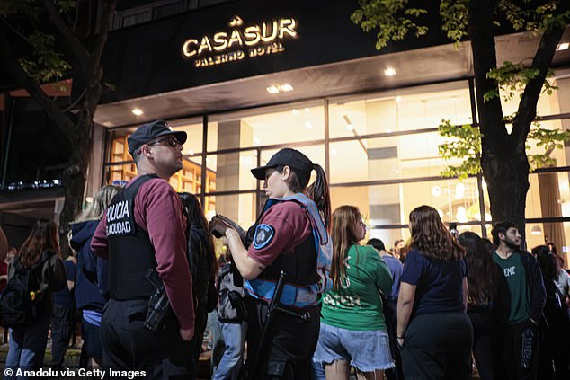 Police officers stand outside the CasaSur hotel on Wednesday