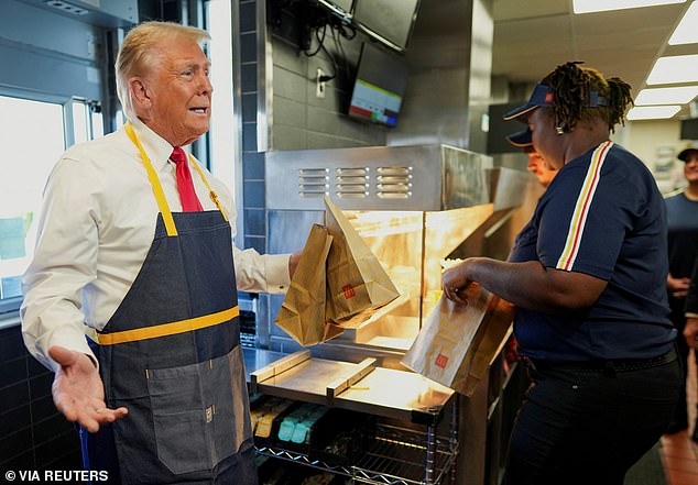 Busy in the kitchen! Trump wore a McDonald's apron as he grabbed to-go orders