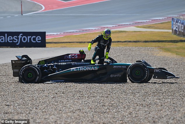 Hamilton, pictured getting out of his car, retired early on a day to soon be forgotten for the Englishman