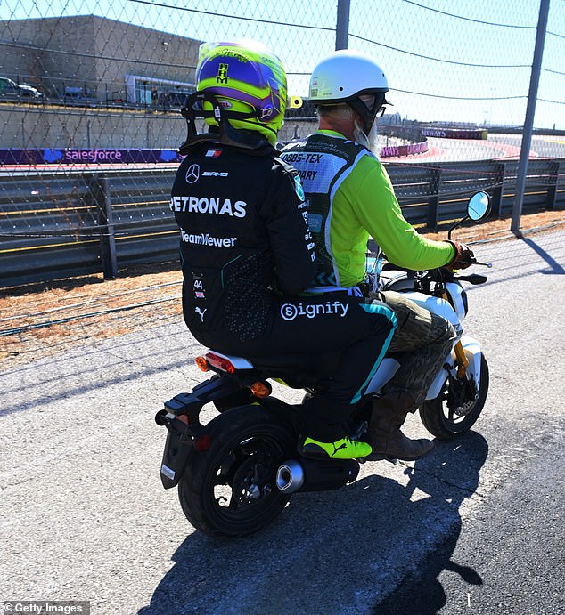 After crashing his car, Hamilton got a ride on the back of a small motorcycle in Austin