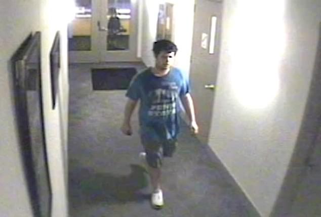 The footage, obtained and cropped by Fox News, shows a man wearing gray shorts and what appears to be a blue Penn State T-shirt holding his phone in his hands as he walks down the hallway to the apartment's gym .