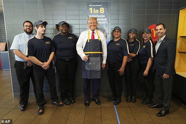 Workers smiled as they posed with Trump at the McDonald's restaurant