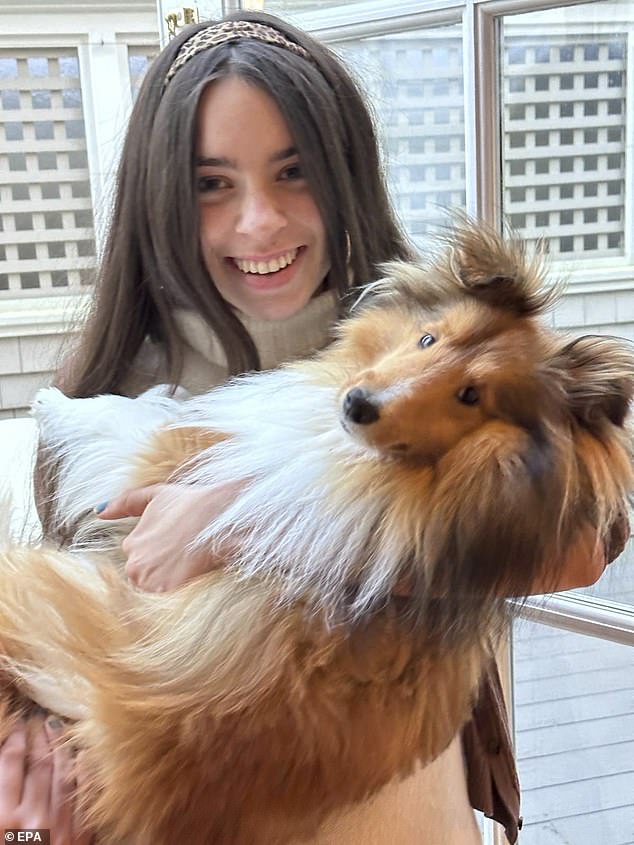 Hannah is pictured cuddling the family's Shetland sheepdog named Faucet, her father's favorite dog