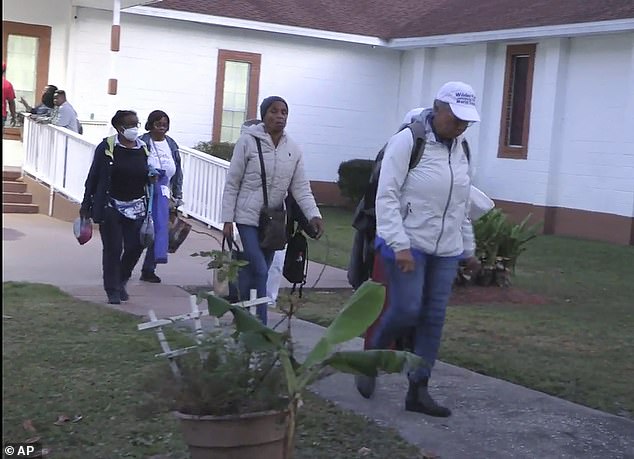 Festival-goers attending a Gullah Geechee festival on Sapelo Island leave the Elm Grove Church where they were taken to reunite with loved ones on Sapelo Island