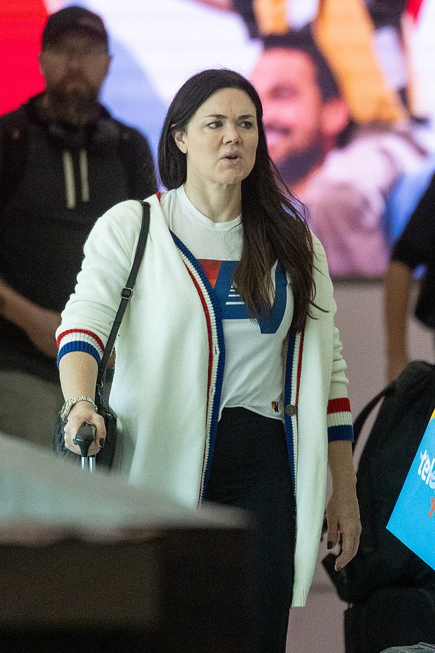 Vanessa wore black tights and white sneakers as she walked through the terminal