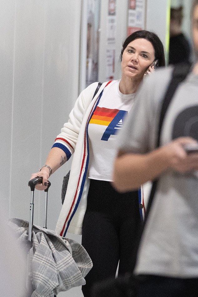 The singer, who moved to the US in 2017, wore her dark hair down and went for a make-up-free look as she returned Down Under.