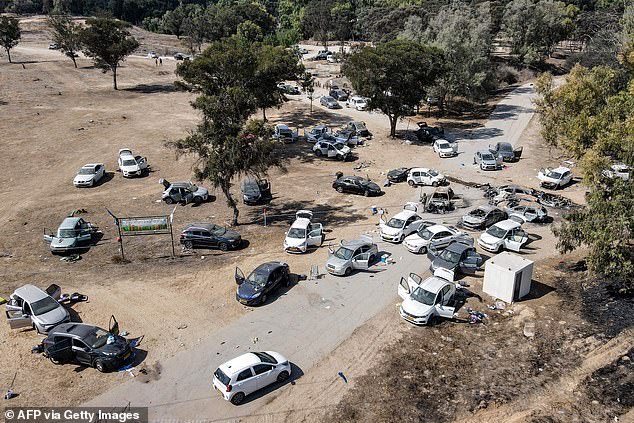 This aerial view shows abandoned and torched vehicles at the site of the October 7 attack on the Supernova Desert Music Festival by Palestinian militants near Kibbutz Reim in the Negev Desert of southern Israel on October 13, 2023