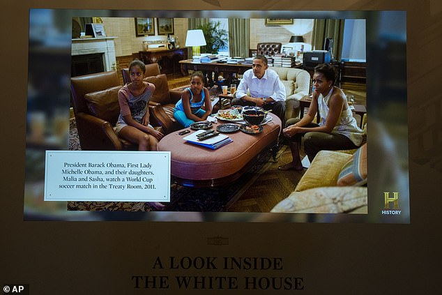 Photos of presidential families at the residence are included - above are Barack and Michelle Obama with Sasha and Malia