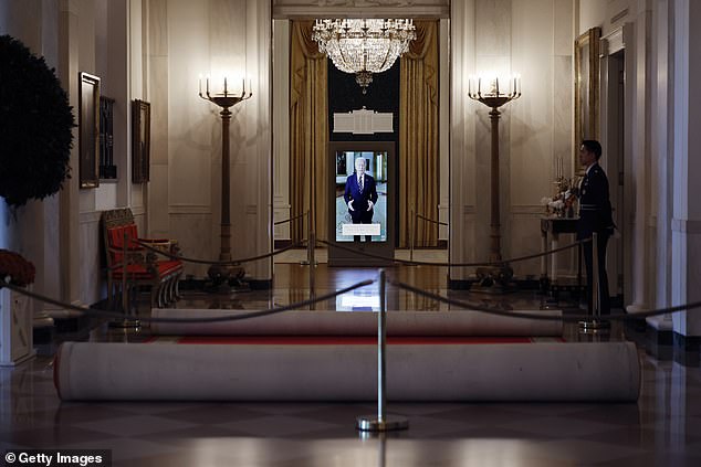 President Joe Biden greets visitors in the East Room