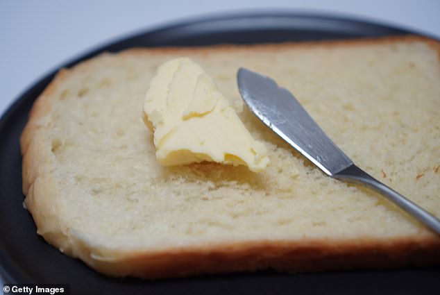 Tear off a small piece of bread and brush it with butter on your side plate; never do this on the table