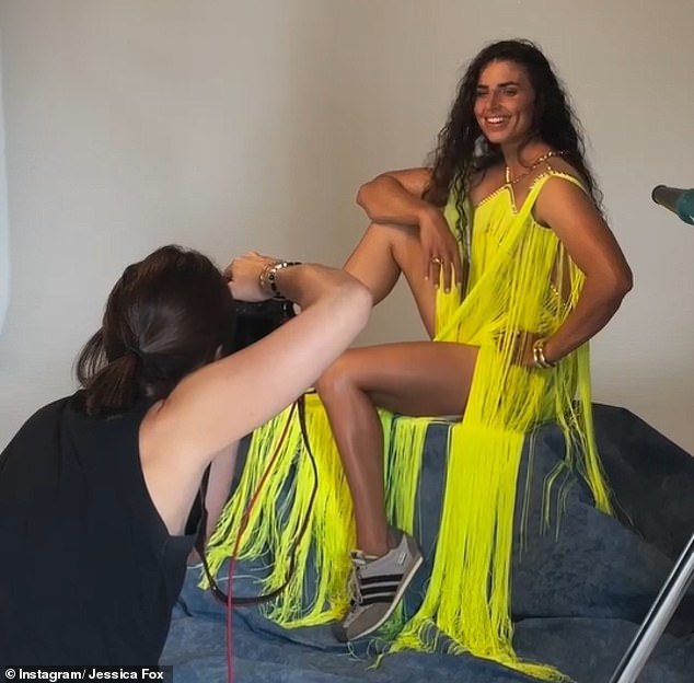 Fox poses for a photo shoot for a magazine cover, later revealing tape was needed to hold the dress together because her broad shoulders would not fit comfortably in the outfit