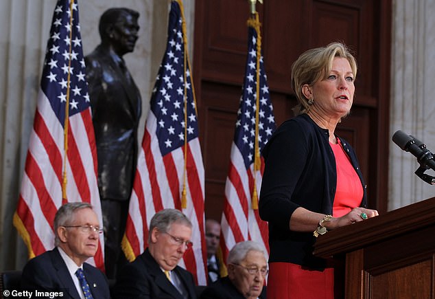 Susan Ford Bales speaks at the U.S. Capitol during the dedication ceremony of her father's statue in May 2011. Behind her are then-Majority Leader Harry Reid, Minority Leader Mitch McConnell and former Secretary of State Henry Kissinger