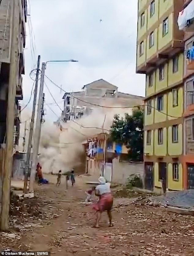 The tall building collapsed in a plume of smoke as locals fled the scene