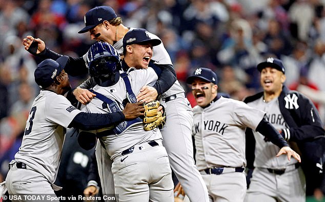 The New York Yankees celebrate after beating the Cleveland Guardians in Game 5 of the ALCS