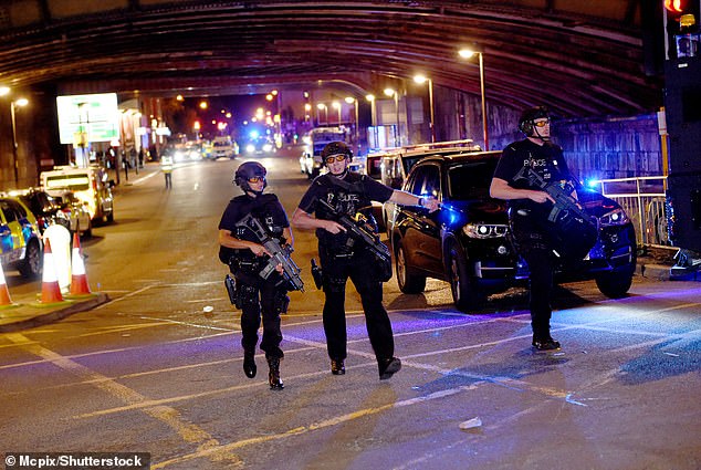 Armed police officers patrol the streets of Manchester after the arena explosion on May 22, 2017