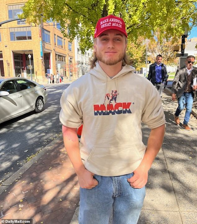 Packing the Heat: Student Dean Davis was impressed by the professionalism of police as he turned in and put away his firearm to cast his first vote for Donald Trump. 