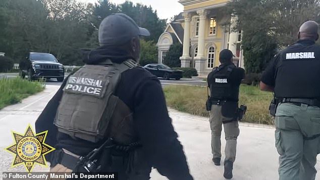 Video of the operation showed a bare house with minimal furnishings as marshals carrying long guns and shields searched the property