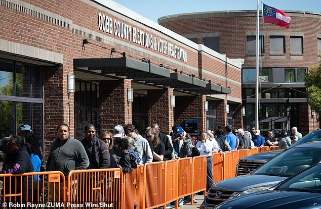 Voters line up in Marietta, Georgia to cast their ballots for the 2024 election. Cobb County is one of the top locations with strong early voting turnout