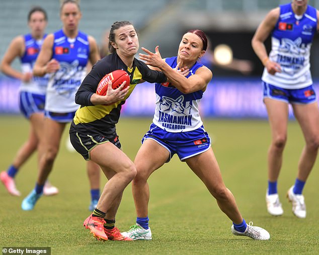 McCarthy (pictured with the ball playing for Richmond this year) says homophobic, sexist and racist comments online must stop