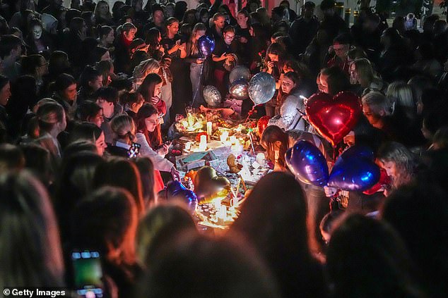 Fans gather at a tribute to Payne at Cathedral Gardens in Manchester on Sunday evening