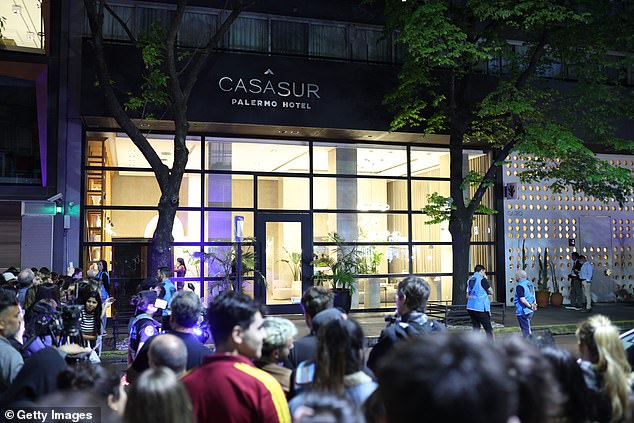 Fans watch as emergency services work at the Casa Sur Hotel in Buenos Aires on October 16