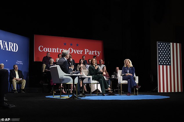 Democratic presidential candidate Vice President Kamala Harris, center, with former Congresswoman Liz Cheney, right, and moderator Charlie Sykes, left, together on stage during a town hall at the Sharon Lynne Wilson Center for the Arts in Brookfield, Wisconsin