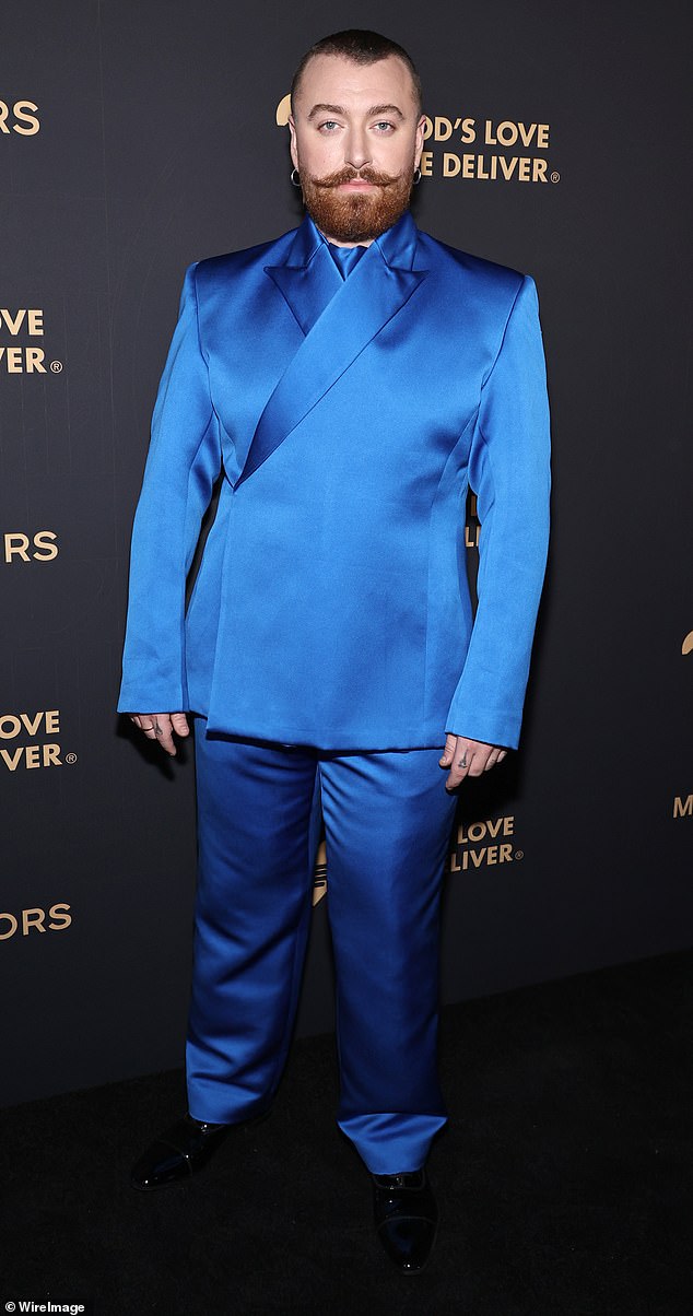 Sam Smith, 32, wore a satin royal blue co-ord set and shiny black dress shoes