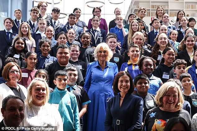 The Queen posed with students, authors and book club members after presenting certificates to former entrants in the Queen's Commonwealth Essay Competition, an annual competition organized by the Royal Commonwealth Society.