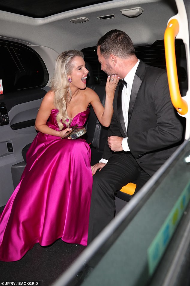 The former Coronation Street star appeared in a giddy mood and packed on the PDA with the footballer as she grabbed his face as they sat in the backseat