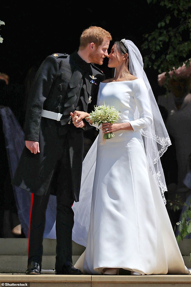 Meghan Markle's wedding dress was designed by Claire Waight Keller. Above: Meghan kisses Prince Harry outside St George's Chapel on their wedding day, May 2018