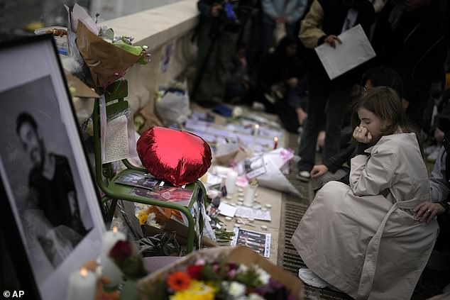 Fans gather to pay tribute to Payne surrounded by candles in Paris