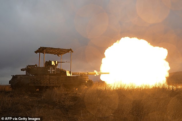 Ukrainian soldiers shoot a tank while checking it after a maintenance job not far from Bakhmut in the Donetsk region on February 5, 2024