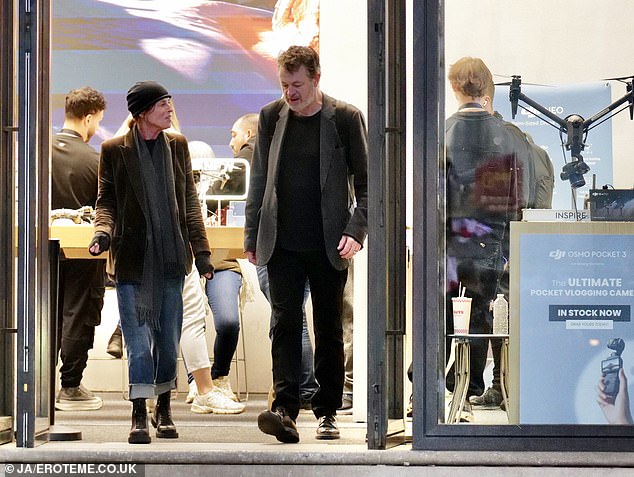 Meanwhile, her husband looked smartly casual in a gray blazer and black sweater as they left the store